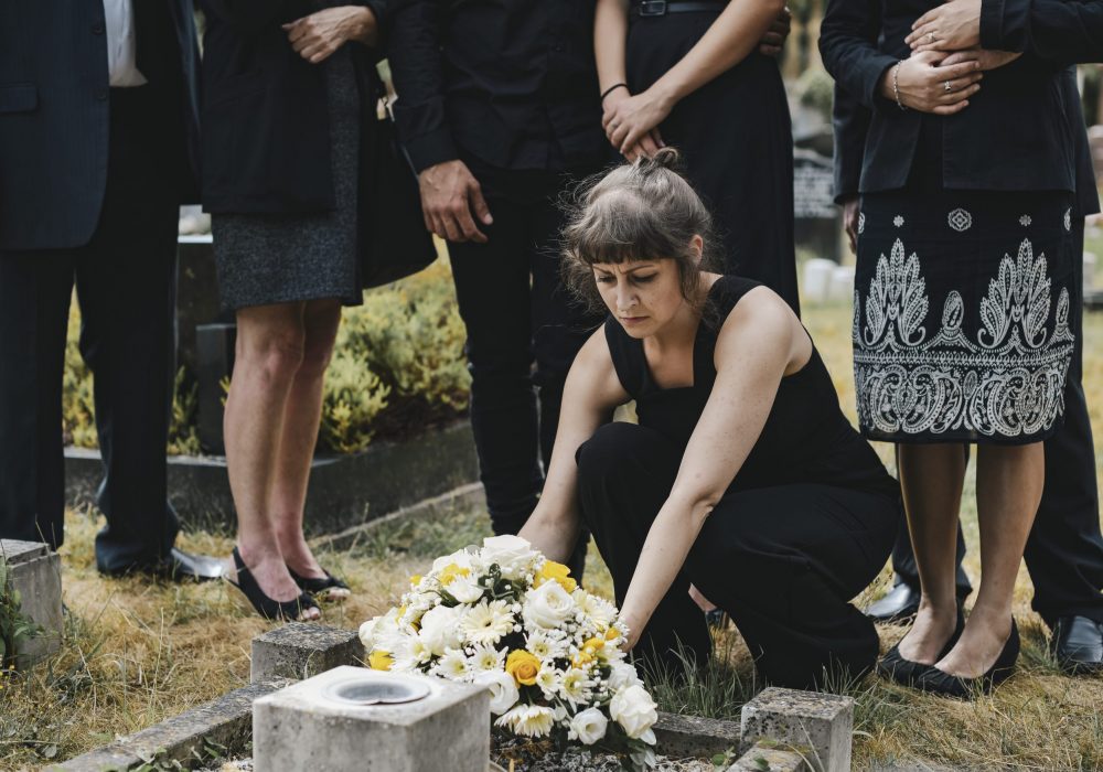 Family laying flowers on the grave